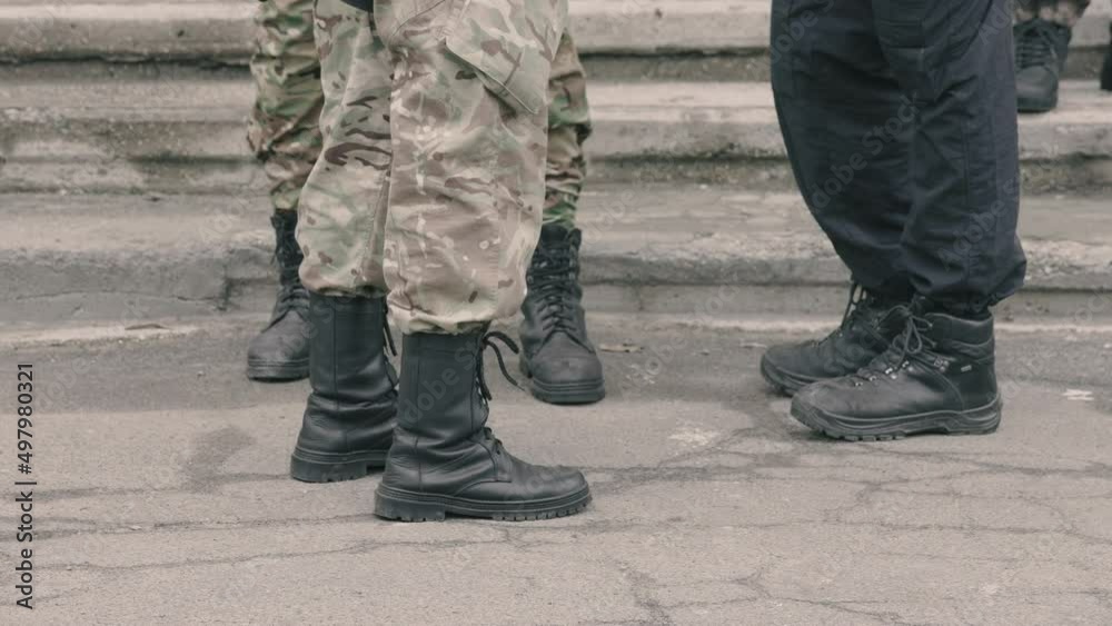 close-up. military feet shod in heavy army boots. old car tires. defensive post in wartime. gloomy day, autumn, summer. soldiers in camouflage military uniforms. in Ukraine. war activities. close-up. military feet shod in heavy army boots. old car tires. defensive post in wartime. gloomy day, autumn, summer. soldiers in camouflage military uniforms. in Ukraine. war activities.