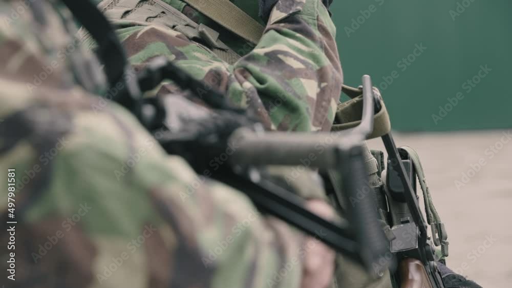 Wideo Stock: people with weapons in their hands. soldiers in camouflage ...