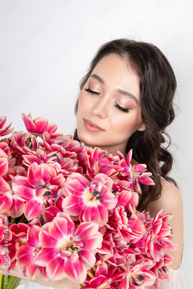 Girl with a bouquet of pink tulips. Girl with a gift of flowers