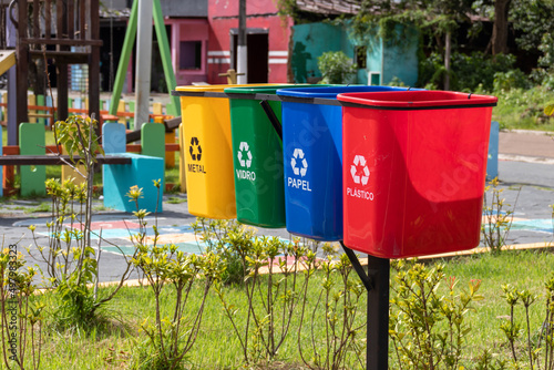 Set of bins for the selective collection of waste (metal, glass, paper, and plastic), in portuguese,  for recycling purposes. photo