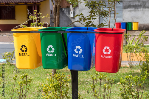 Photography Set of bins for the selective collection of waste (metal, glass, paper, and plastic), in portuguese,  for recycling purposes