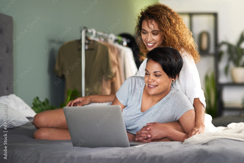 Lets use the search engine to find the website. Shot of a young couple using a laptop while lying on their bed. Lets use the search engine to find the website. Shot of a young couple using a laptop while lying on their bed.