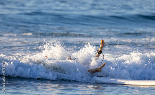 Photography Surfer splashing into the water while surfing on the ocean
