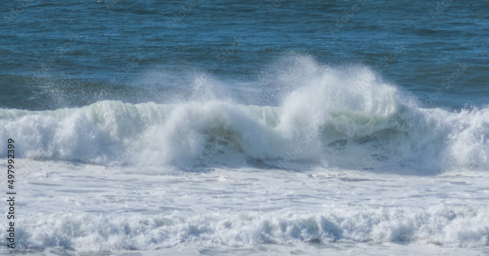 Cascading waves crashing and spraying off the coast of Oregon