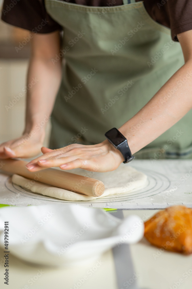 Partial view of kitchen worktop with cooking and hands of chef with electronic clock. Copy space, vertical Partial view of kitchen worktop with cooking and hands of chef with electronic clock. Copy space, vertical