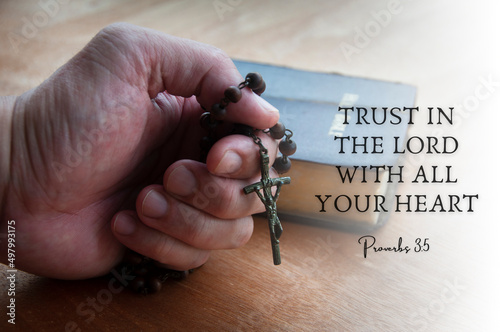 Quote from Bible with hand holding Holy Rosary background. Religious concept