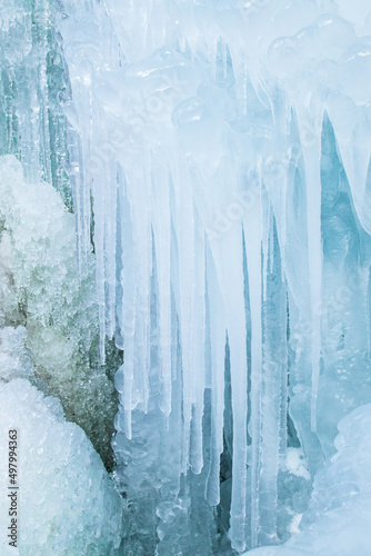 Winter vertical background made of ice, icicles, frozen water drops