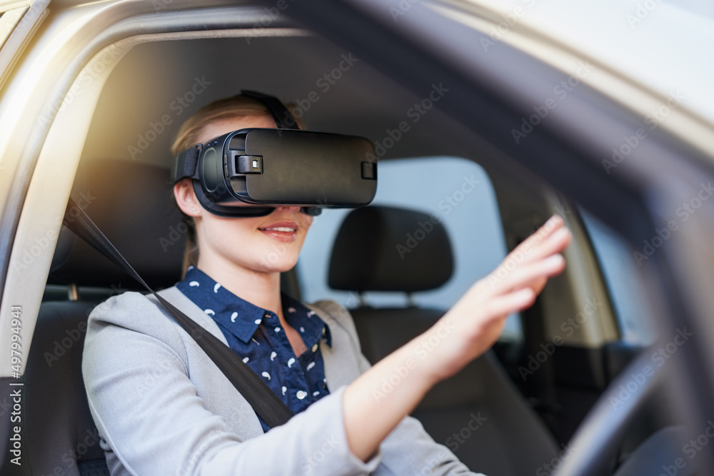Integrating virtual reality into the driving experience. Cropped shot of a young businesswoman driving while wearing a virtual reality headset.