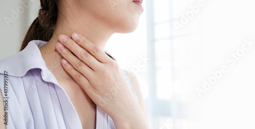 Woman with sore throat inflamed tonsils from influenza symptoms. Healthcare and medical concept photo
