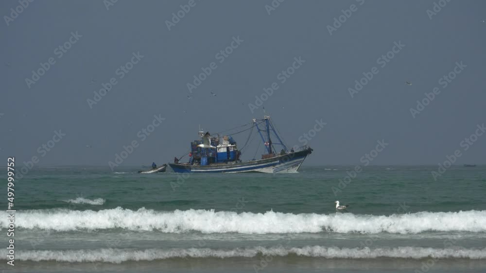 A fishing trawler filmed from the beach in Essaouira, Morocco A fishing trawler filmed from the beach in Essaouira, Morocco