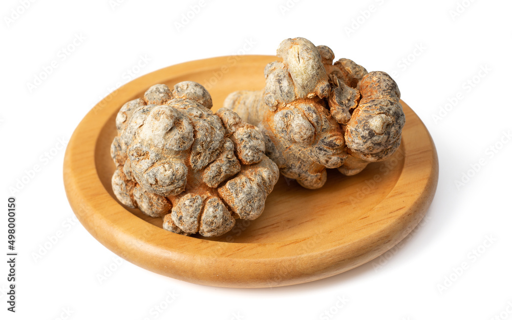 Dried notoginseng roots in the wooden bowl, isolated on the white background. Dried notoginseng roots in the wooden bowl, isolated on the white background.