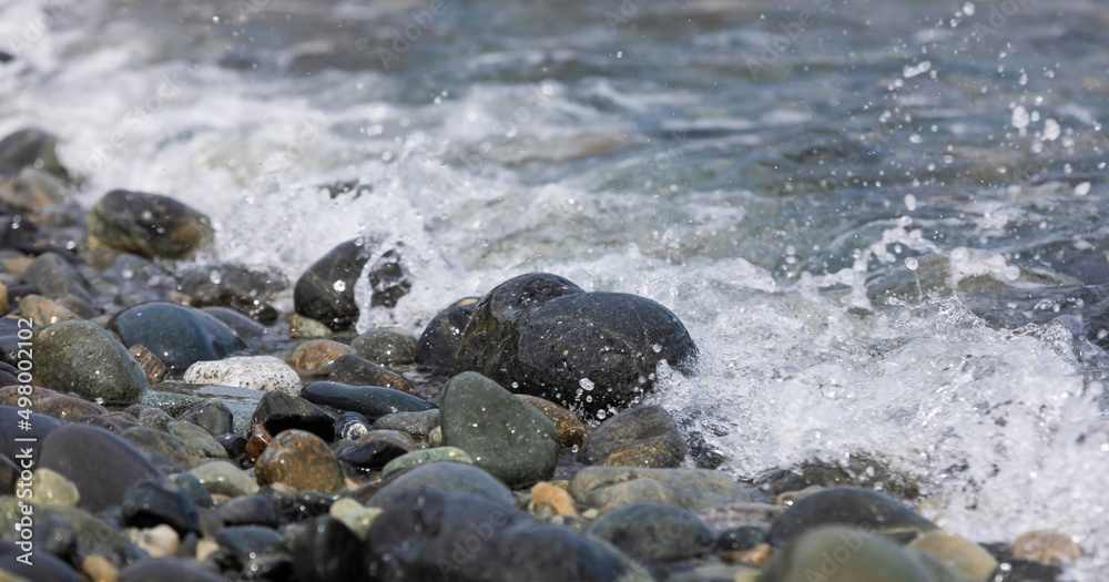 Beach stones soaking in the waves Beach stones soaking in the waves