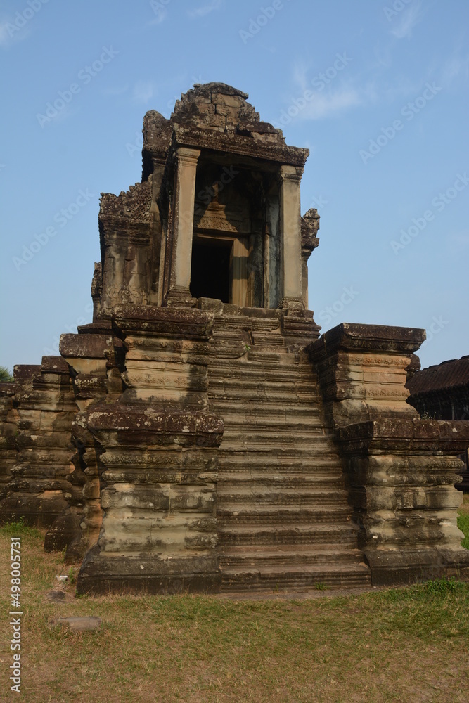 The ruins of Angkor Wat complex on a sunny early morning - the sunrise starting to illuminate the stone buildings
