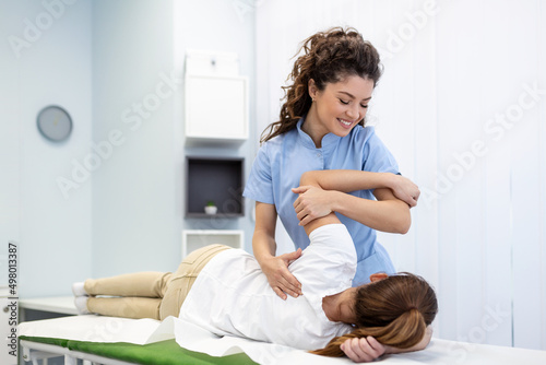 Physiotherapist treatment patient. Holding patient's hand, shoulder joint treatment. Physical Doctor consulting with patient About Shoulder muscule pain problems Physical therapy diagnosing concept photo