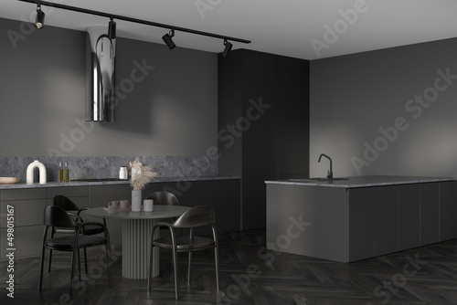 Corner view on dark kitchen room interior with dining table