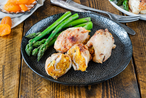 Chicken thighs with appricot stuffing and asparagus photo