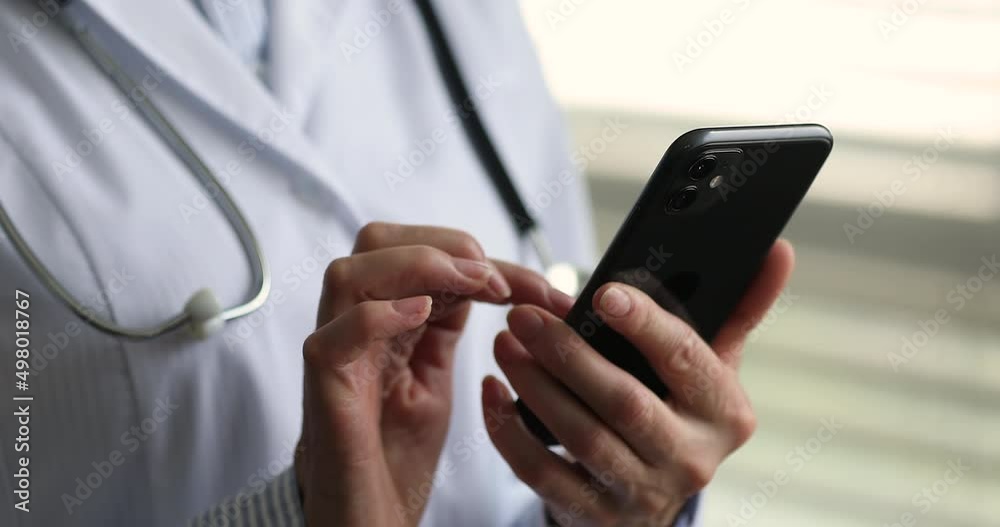 Smart medicare. Close up mobile phone device in female doctor hands. Modern day physician contact patient remotely in web chat give urgent recommendation write treatment prescription online using cell Smart medicare. Close up mobile phone device in female doctor hands. Modern day physician contact patient remotely in web chat give urgent recommendation write treatment prescription online using cell