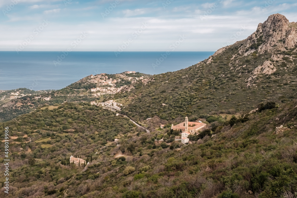 Convent outside the hilltop village of Corbara in the Balagne region of Corsica with Mediterranean sea in the distance