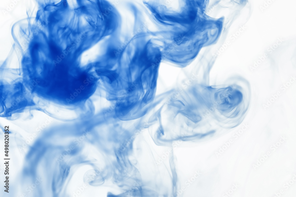 Puffs of paint in water. The dissolution of the dye in water. Water pollution. Concept art creativity.