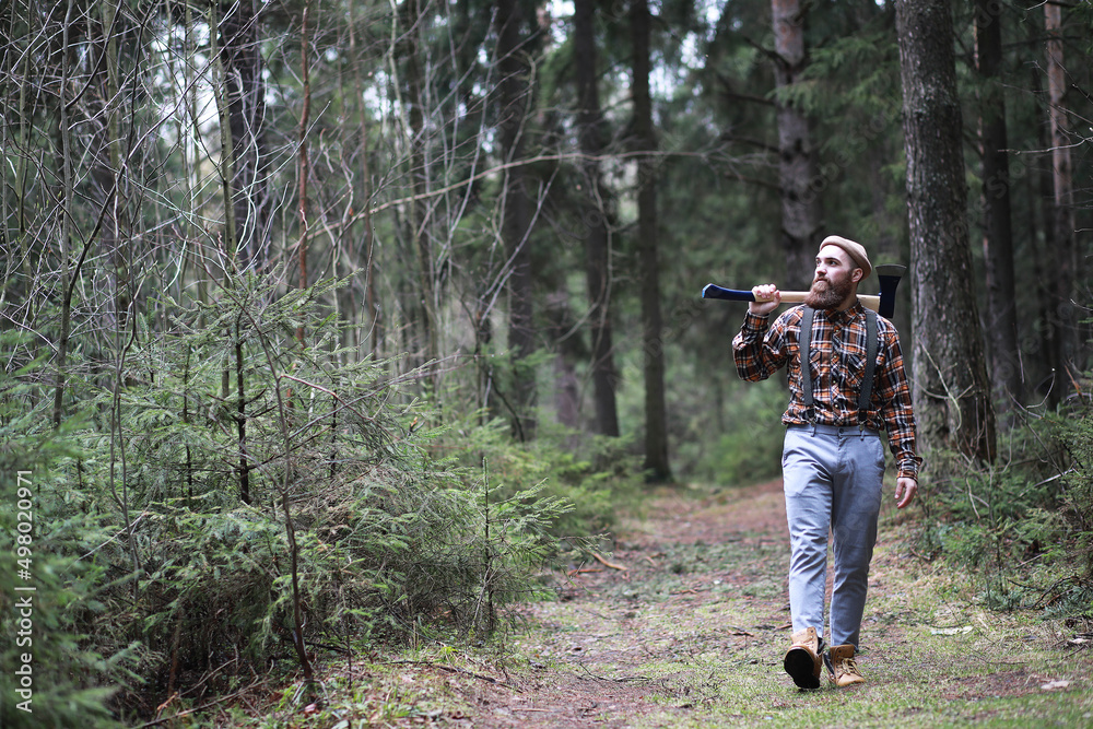 Fototapeta premium A bearded lumberjack with a large ax