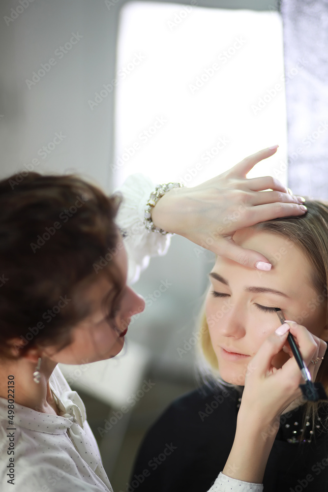 Fototapeta premium Young girl with a make-up artist