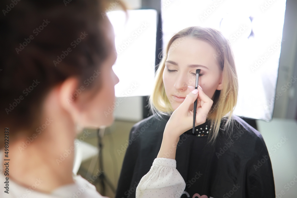Young girl with a make-up artist Young girl with a make-up artist