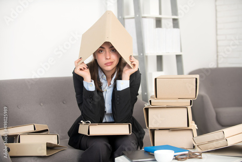 Sad busy secretary with many folders of documents, stressed overworked business woman too much work, office problem. Tired stressed employee at workspace.