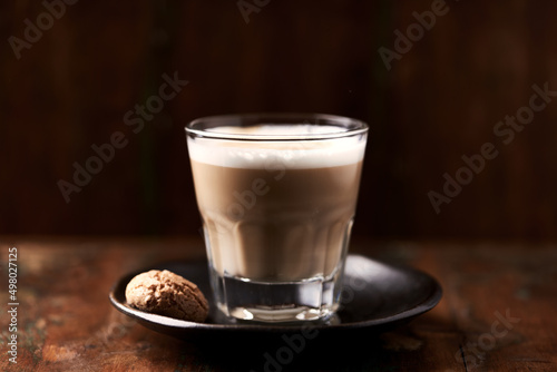 Coffee with milk on dark wooden background. Soft focus. Close up. Copy space. 