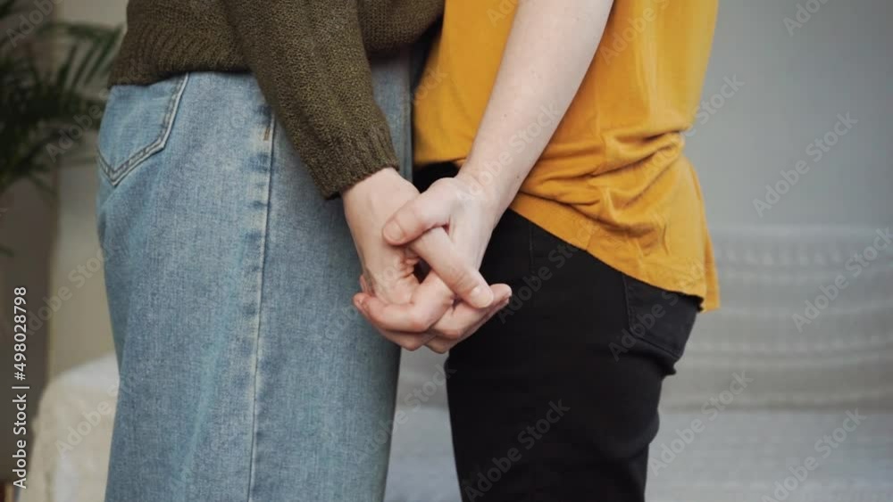 Two girls hold hands