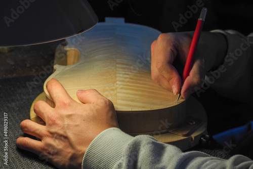 Fotografie luthier working on a new violin in his workshop