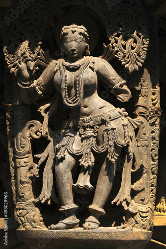 Stone Sculpture of Beautiful Female (Madanikas) with selective focus, 12th century Hindu temple, Ancient stone art and sculptures in each pillars, Chennakeshava Temple, Belur, Karnataka, India. photo