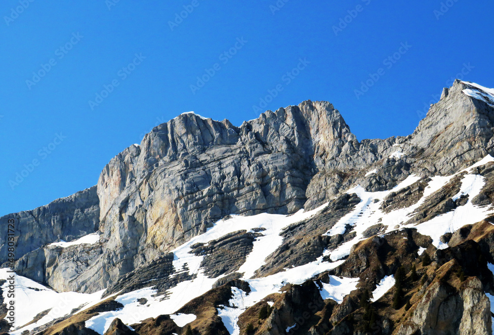 Rocky peak Mutteristock (2295 m) in the in the Schwyz Prealps mountain range, and over the Wägitalersee reservoir lake (Waegitalersee or Wagitaler lake) - Canton of Glarus, Switzerland (Schweiz)