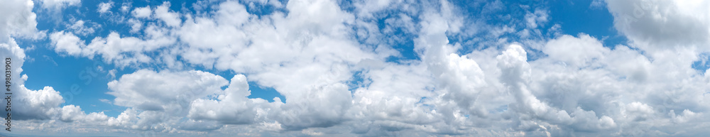 Panoramic view of blue sky with fluffy clouds Panoramic view of blue sky with fluffy clouds