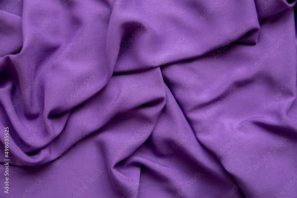 Purple fabric background. The texture of the fabric. Purple fabric background. The texture of the fabric.