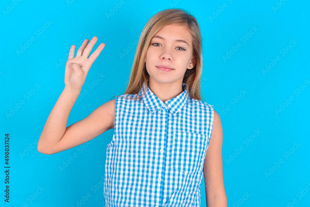 little kid girl with glasses wearing plaid shirt over blue background showing and pointing up with fingers number four while smiling confident and happy. little kid girl with glasses wearing plaid shirt over blue background showing and pointing up with fingers number four while smiling confident and happy.