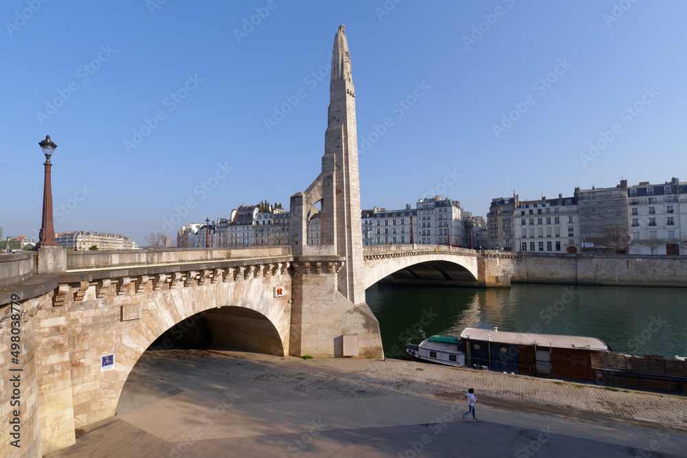 Jogging on the Seine river quay near the Tournelle bridge in Paris 
