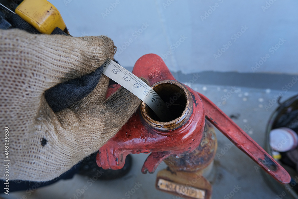 Sounding of fuel, diesel oil tank using finding ruler tape Stock Photo ...