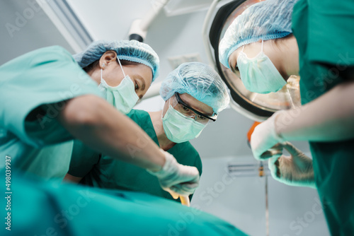 Konstfotografi Low Angle Shot of Professional surgeons team performing surgery in operating roo