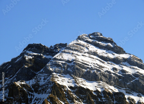 Alpine peak Usser Fürberg (Usser Fuerberg or Usser Furberg, 2605 m) in the Glarus Alps mountain range, over the Klöntalersee reservoir lake and Klöntal alpine valley - Canton of Glarus, Switzerland photo