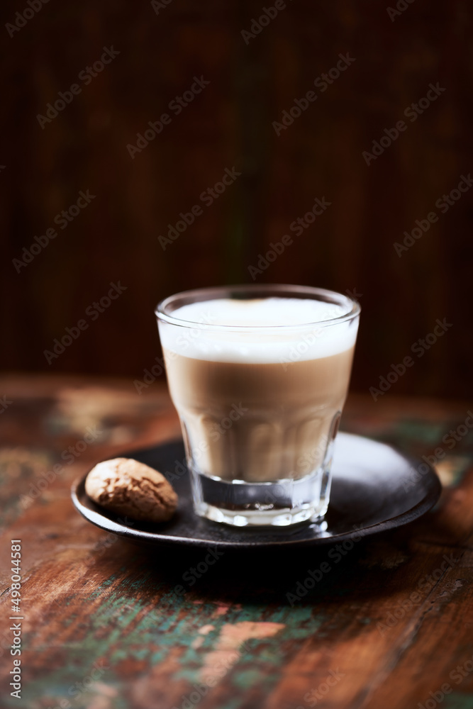 Coffee with milk on rustic wooden background. Soft focus. Close up. Copy space. Coffee with milk on rustic wooden background. Soft focus. Close up. Copy space.