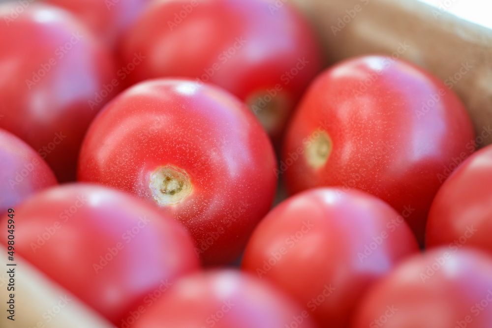 Lot of ripe red tomatoes in shop window background closeup Lot of ripe red tomatoes in shop window background closeup
