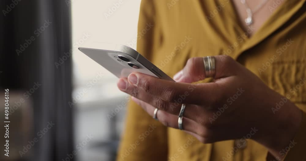 Cellphone user. Close up teenage Black female wear stylish rings on hand hold smartphone work online via wireless internet. Young lady use mobile app on cell gadget chat browse web scroll social media Cellphone user. Close up teenage Black female wear stylish rings on hand hold smartphone work online via wireless internet. Young lady use mobile app on cell gadget chat browse web scroll social media