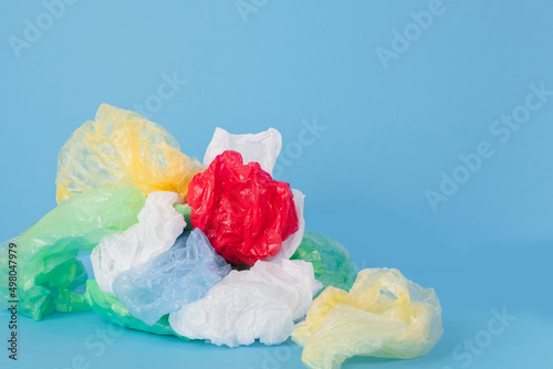 Plastic bags and plastic wraps of different colors on a blue background. no plastic concept.  photo