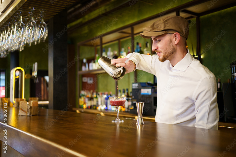 Bearded bartender preparing cocktail in pub Bearded bartender preparing cocktail in pub