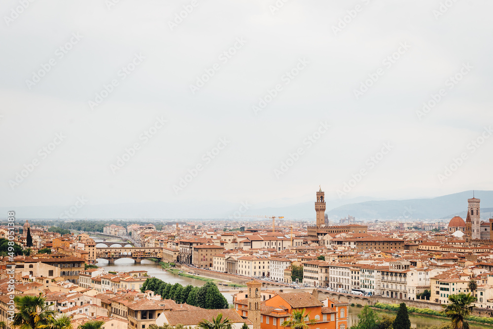 Panoramic view of Florence city with Palazzo Vecchio, Ponte Vecchio and Arno river from the Piazzale Michelangelo on a cloudy day, Tuscany, Italy. Italian famous travel destination