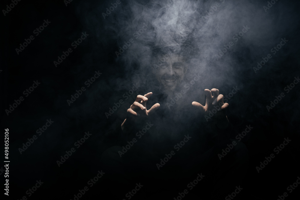 smoke clouds arround man with a hat on dark background smoke clouds arround man with a hat on dark background