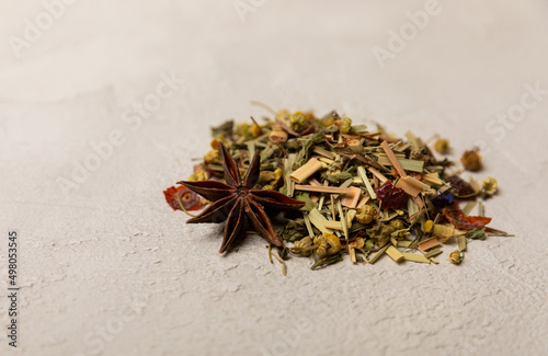 Dry herbal tea on a gray cement background.Side view.Children and immunity tea.Copy space. Place for text.