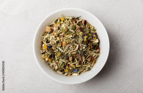 Herbal tea in a white ceramic bowl and spices on a light background. tea for immunity and detox.  space for text. Tea ceremony