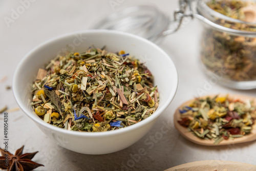 Herbal tea in a white ceramic bowl and spices on a light background. tea for immunity and detox.  space for text. Tea ceremony