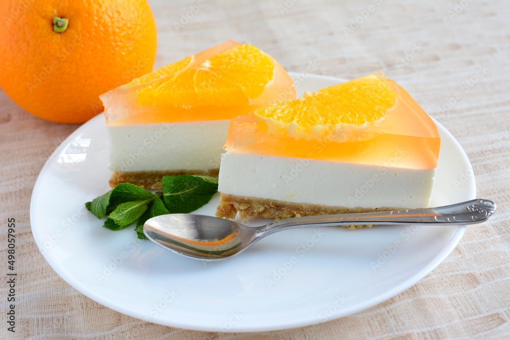 cut pieces of orange cake on plate on beige background, close-up cut pieces of orange cake on plate on beige background, close-up